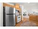 Bright kitchen featuring stainless steel refrigerator, wood cabinets, and hardwood flooring at 210 Millet Dr, Morrisville, NC 27560