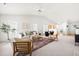 Bright, open-concept living room with plenty of seating, natural light, and views into the kitchen and entry at 210 Millet Dr, Morrisville, NC 27560