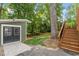 Backyard with a storage shed and stairs leading to a higher wooden deck at 2114 Woodview Dr, Raleigh, NC 27604