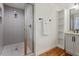 Bright bathroom featuring a glass shower and storage shelves adjacent to the vanity at 2114 Woodview Dr, Raleigh, NC 27604