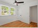 Bedroom features hardwood floors, two windows with blinds, a ceiling fan and a closet at 2114 Woodview Dr, Raleigh, NC 27604