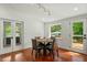 Bright dining room with hardwood floors, natural light, and access to the deck at 2114 Woodview Dr, Raleigh, NC 27604