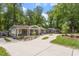 Sprawling property featuring a long driveway and lush landscaping, providing serene curb appeal at 2114 Woodview Dr, Raleigh, NC 27604