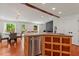 Open kitchen with an island featuring granite countertops, stainless steel dishwasher and hardwood floors at 2114 Woodview Dr, Raleigh, NC 27604