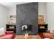 A modern fireplace highlights this living room with hardwood floors, comfortable seating, and built-in shelves at 2114 Woodview Dr, Raleigh, NC 27604