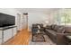 Cozy living room featuring hardwood floors, neutral paint, and comfortable gray sofas at 2114 Woodview Dr, Raleigh, NC 27604