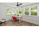 Bright sunroom with multiple windows, tile floors, and a cozy seating area with a desk at 2114 Woodview Dr, Raleigh, NC 27604