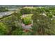 Aerial view showing a home nestled among trees, with nearby fields, solar panels, and power lines at 213 Old Mallard Rd, Smithfield, NC 27577