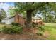 Brick home with a backyard including a wooden deck, mature trees, and landscaping at 213 Old Mallard Rd, Smithfield, NC 27577
