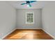 Cozy bedroom featuring hardwood floors, a large window, and a modern ceiling fan with lighting at 213 Old Mallard Rd, Smithfield, NC 27577