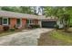 Charming brick home with well-maintained landscaping and a curved driveway leading to the attached garage at 213 Old Mallard Rd, Smithfield, NC 27577