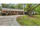 Charming red brick home featuring a well-manicured lawn and a curved driveway leading to the front entrance at 213 Old Mallard Rd, Smithfield, NC 27577
