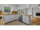 Kitchen with white cabinets, wood countertop, stainless steel dishwasher, and views to the living room at 213 Old Mallard Rd, Smithfield, NC 27577