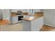 Bright kitchen with wood countertops, white cabinetry, modern appliances, and a cozy breakfast bar at 213 Old Mallard Rd, Smithfield, NC 27577