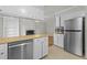 Bright kitchen featuring white cabinets, wood countertops, stainless steel appliances, and an open view to the living room at 213 Old Mallard Rd, Smithfield, NC 27577