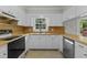 Charming kitchen with white cabinets, black appliances, wooden countertops, stainless steel dishwasher, and tile flooring at 213 Old Mallard Rd, Smithfield, NC 27577