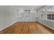 Spacious room featuring hardwood floors, a large window, and custom built-in shelving with cabinetry at 213 Old Mallard Rd, Smithfield, NC 27577