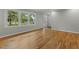 Inviting living room with hardwood floors, large windows, neutral walls, and ample natural light at 213 Old Mallard Rd, Smithfield, NC 27577