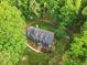 An aerial view showing a well-maintained home surrounded by lush landscaping and mature trees at 2169 Rawls Church Rd, Angier, NC 27501