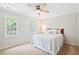 Comfortable bedroom features plush carpet, natural light, and a ceiling fan at 2169 Rawls Church Rd, Angier, NC 27501