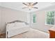Bright bedroom features a large window and ceiling fan, offering a comfortable space at 2169 Rawls Church Rd, Angier, NC 27501