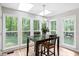 Bright breakfast nook with lots of natural light and views of the private, wooded backyard at 2169 Rawls Church Rd, Angier, NC 27501