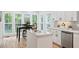 Bright kitchen with an island, breakfast nook, and view of the private, wooded backyard at 2169 Rawls Church Rd, Angier, NC 27501