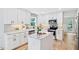 Modern kitchen featuring white cabinets, an island, stainless appliances, and a gray backsplash at 2169 Rawls Church Rd, Angier, NC 27501