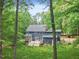 A charming two-story home with a well-maintained lawn and mature trees at 2169 Rawls Church Rd, Angier, NC 27501