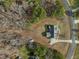 An aerial view of the home nestled amongst trees, with a long driveway at 226 Fletcher Ridge Rd, Timberlake, NC 27583