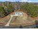 Aerial view of a charming home with a large yard, long driveway, and a shed in the back at 226 Fletcher Ridge Rd, Timberlake, NC 27583