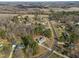 Aerial view of homes in a wooded neighborhood with long driveways and lush landscaping at 226 Fletcher Ridge Rd, Timberlake, NC 27583