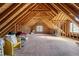 Unfinished attic space with exposed wood beams and a window at 226 Fletcher Ridge Rd, Timberlake, NC 27583