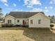View of the home's backyard featuring a seating area and mature trees at 226 Fletcher Ridge Rd, Timberlake, NC 27583