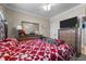 Comfortable bedroom with a red and white patterned quilt, dresser, and a cozy atmosphere at 226 Fletcher Ridge Rd, Timberlake, NC 27583