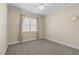 This bedroom has neutral colored walls, carpet flooring, a window and a ceiling fan at 226 Fletcher Ridge Rd, Timberlake, NC 27583