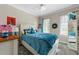 Charming bedroom featuring a blue quilted bed and bright windows, perfect for relaxing at 226 Fletcher Ridge Rd, Timberlake, NC 27583