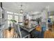 Open dining area featuring hardwood floors, bright windows, and seamless flow to the kitchen at 226 Fletcher Ridge Rd, Timberlake, NC 27583