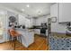 Kitchen features custom cabinets, stainless steel appliances, and a cozy breakfast bar at 226 Fletcher Ridge Rd, Timberlake, NC 27583