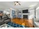 Spacious living room featuring a fireplace, hardwood floors, and modern decor at 226 Fletcher Ridge Rd, Timberlake, NC 27583