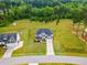Aerial view of house situated on spacious lawn featuring long driveway and manicured lawn at 233 Berg St, Smithfield, NC 27577
