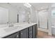 A bright bathroom features a double vanity with modern fixtures, a large mirror, and tiled shower at 233 Berg St, Smithfield, NC 27577