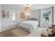 A stylish bedroom boasts natural light, modern decor, and a cozy area rug at 233 Berg St, Smithfield, NC 27577
