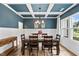 Dining room with coffered ceiling, wood table, and wainscoting at 233 Berg St, Smithfield, NC 27577