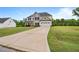View of the home from a long driveway; showcasing the lawn and two-car garage at 233 Berg St, Smithfield, NC 27577