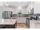 Modern kitchen with white cabinets, granite countertops, stainless steel appliances, and stylish gray backsplash at 233 Berg St, Smithfield, NC 27577