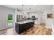 Bright kitchen with black island, granite countertops, stainless steel appliances, and modern pendant lights at 233 Berg St, Smithfield, NC 27577