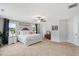 A spacious main bedroom features a ceiling fan, natural light, and neutral-toned walls and carpet at 233 Berg St, Smithfield, NC 27577