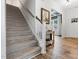 Carpeted staircase with wood handrail leading to the upper level at 233 Berg St, Smithfield, NC 27577