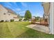 Large backyard featuring a concrete patio, a wooden deck, and green grass at 2429 Follow Me Way, Raleigh, NC 27610